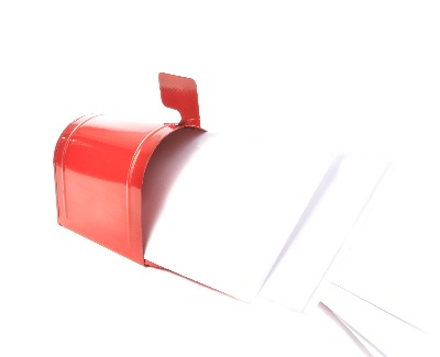Red mailbox over flowing with mail. 